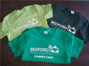 photo of 3 hues of green tshirts with Bedford Parks & Rec logo