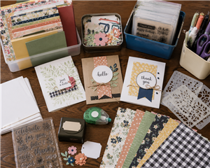 Table with scrapbook papers and supplies to make cards