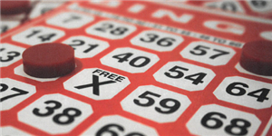 red and white bingo board with red chips